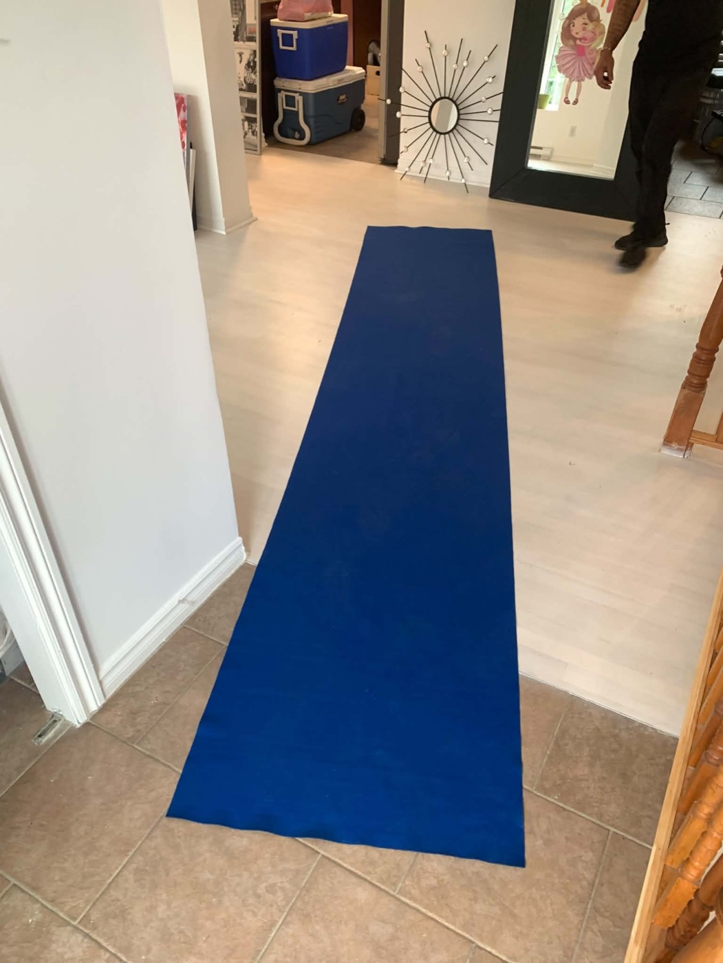 Blue floor runner laid from the front door through the entry of a home on moving day