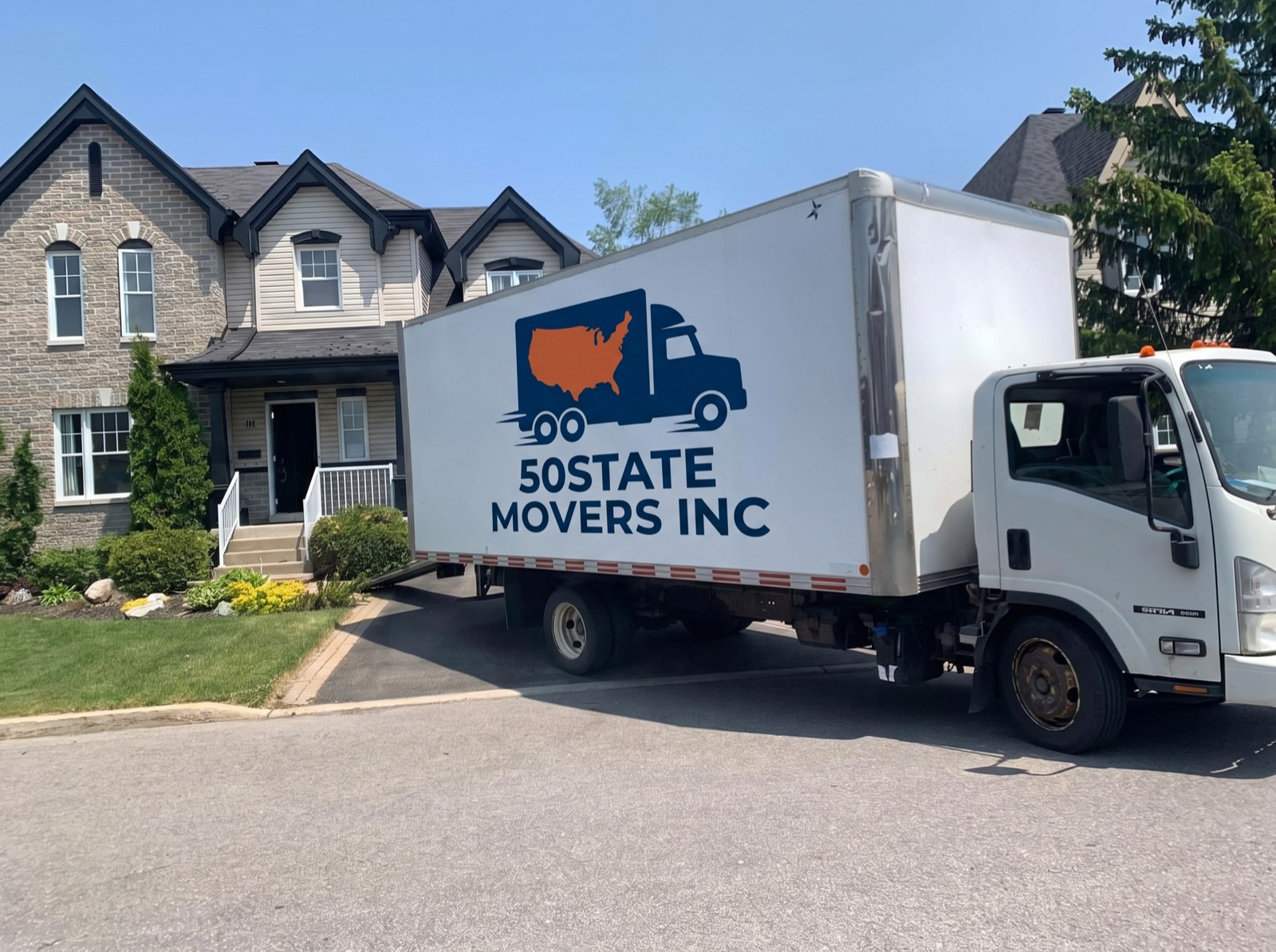 50STATE MOVERS INC box truck in its own livery parked at the front door of a house on delivery day
